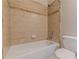 A tiled shower and white porcelain toilet are featured in this neutral toned bathroom at 683 Pryor Sw St # C, Atlanta, GA 30315