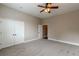 Bright bedroom showcases double closets, neutral carpet, paint, and trim with a ceiling fan at 683 Pryor Sw St # C, Atlanta, GA 30315