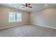 Spacious bedroom features neutral carpet, paint, and trim and a window providing natural light at 683 Pryor Sw St # C, Atlanta, GA 30315