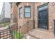 Brick stairs lead up to a wrought iron security door and entrance of townhome at 683 Pryor Sw St # C, Atlanta, GA 30315