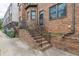 Brick stairs lead up to a wrought iron security door and entrance of townhome at 683 Pryor Sw St # C, Atlanta, GA 30315