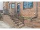 Brick stairs lead up to a wrought iron security door and entrance of townhome at 683 Pryor Sw St # C, Atlanta, GA 30315