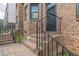 Brick stairs lead up to a wrought iron security door and entrance of townhome at 683 Pryor Sw St # C, Atlanta, GA 30315