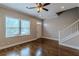 Bright living room features hardwood floors, a ceiling fan, and a staircase at 683 Pryor Sw St # C, Atlanta, GA 30315