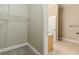 This walk-in closet includes wire shelving for storage in carpeted area and open access to tiled bathroom at 683 Pryor Sw St # C, Atlanta, GA 30315