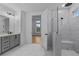Bathroom showcasing double vanity, marble tile floors, and a modern glass shower at 231 Strawberry Ln, Woodstock, GA 30189