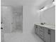 Bathroom showcasing double vanity, marble tile floors, and a glass enclosed shower at 231 Strawberry Ln, Woodstock, GA 30189