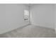 Carpeted bedroom with neutral walls and a window at 231 Strawberry Ln, Woodstock, GA 30189