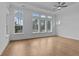 Spacious bedroom featuring hardwood floors, recessed lighting, and a wall of large windows at 231 Strawberry Ln, Woodstock, GA 30189