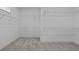 Walk-in closet with wall mounted wire shelving and gray carpet at 231 Strawberry Ln, Woodstock, GA 30189