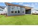 Home exterior with covered patio, gray siding, and large windows overlooking the backyard at 231 Strawberry Ln, Woodstock, GA 30189