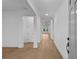 Bright, neutral hallway with hardwood floors and white trim, leading to other rooms at 231 Strawberry Ln, Woodstock, GA 30189