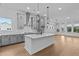 Modern kitchen featuring gray cabinets, a white quartz island, and stainless steel appliances at 231 Strawberry Ln, Woodstock, GA 30189