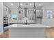 New kitchen boasts large island, gray cabinets, stainless appliances, and modern pendant lights at 231 Strawberry Ln, Woodstock, GA 30189