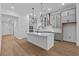 Bright, open kitchen with gray cabinets, stainless appliances, and a large central island at 231 Strawberry Ln, Woodstock, GA 30189