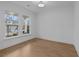 A bright, neutral office space with hardwood floors, white trim, and large windows at 231 Strawberry Ln, Woodstock, GA 30189