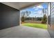 Covered patio with gray siding overlooking a grassy backyard at 231 Strawberry Ln, Woodstock, GA 30189