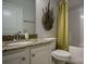 Bathroom with granite countertop, white cabinets, and a shower with tile surround at 255 Eason St, Bowdon, GA 30108