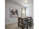 Bright bonus room, carpeted, with a modern art piece and casual high-top seating at 255 Eason St, Bowdon, GA 30108