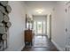 Bright foyer with dark wood floor, decorative mirror, console table and view to front door at 255 Eason St, Bowdon, GA 30108
