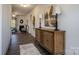 Spacious foyer with hard surface flooring, console table and decor leading to the living room at 255 Eason St, Bowdon, GA 30108