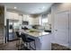 Modern kitchen featuring white cabinets, stainless steel appliances, granite countertops, and a center island at 255 Eason St, Bowdon, GA 30108