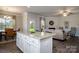 Open concept kitchen with an island open to a living and dining space with lots of light at 255 Eason St, Bowdon, GA 30108