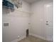 A clean laundry room with utility connections, tile floor, and wire shelving at 255 Eason St, Bowdon, GA 30108