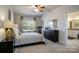 Relaxing main bedroom with a ceiling fan and view to the attached bathroom at 255 Eason St, Bowdon, GA 30108
