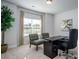 Home office with large window, a modern desk setup and seating for two at 255 Eason St, Bowdon, GA 30108