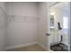 Walk-in closet area leading to a bathroom with granite vanity and a tub at 255 Eason St, Bowdon, GA 30108