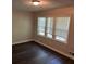 Bedroom showcasing new vinyl floors and bright window at 624 Moselle Sw Dr, Mableton, GA 30126