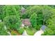 Aerial view of the two-story home surrounded by lush greenery and mature trees at 210 Malvern Pl, Roswell, GA 30076