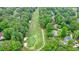 Aerial view of a house on a golf course surrounded by mature trees at 210 Malvern Pl, Roswell, GA 30076
