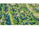 Aerial view of a neighborhood, showcasing tree-lined streets, beautiful homes, and the nearby golf course at 210 Malvern Pl, Roswell, GA 30076