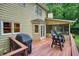 Home's deck shows wooded backyard with grill and outdoor furniture, with a view of the lush landscaping at 210 Malvern Pl, Roswell, GA 30076