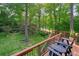 View of a spacious backyard from the deck with seating area and lush landscaping at 210 Malvern Pl, Roswell, GA 30076
