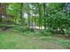 Mature trees and verdant landscaping in the backyard create a private, peaceful setting at 210 Malvern Pl, Roswell, GA 30076