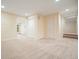 Expansive finished basement area with neutral paint, plush carpeting and recessed lighting throughout at 210 Malvern Pl, Roswell, GA 30076