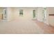 Large basement area with plush carpet, multiple doors, and ample natural light from the windows at 210 Malvern Pl, Roswell, GA 30076