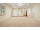 Finished basement with plush carpet, recessed lighting, and access to a sink area with tile flooring at 210 Malvern Pl, Roswell, GA 30076