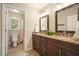 Bathroom with double sink vanity, granite countertop, updated fixtures and tile floor, with view into shower at 210 Malvern Pl, Roswell, GA 30076
