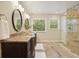 Bright bathroom with a double vanity, modern lighting, and a glass-enclosed shower at 210 Malvern Pl, Roswell, GA 30076