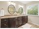 Bathroom featuring a double vanity with granite countertops, framed mirrors, and tiled floors at 210 Malvern Pl, Roswell, GA 30076