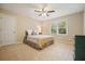 Cozy bedroom features a ceiling fan, neutral carpeting, a double window, and an accent wall paint color at 210 Malvern Pl, Roswell, GA 30076
