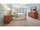 Spacious bedroom with a wood bed frame, lots of natural light, and a calming color palette at 210 Malvern Pl, Roswell, GA 30076