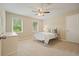 Cozy bedroom with neutral walls, plush carpeting, and a ceiling fan at 210 Malvern Pl, Roswell, GA 30076