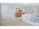 Light-filled bedroom with a large dresser, plush carpet, and a relaxing atmosphere at 210 Malvern Pl, Roswell, GA 30076