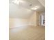 Empty bonus room with neutral carpeting, pitched ceilings, modern light fixtures and open doorway at 210 Malvern Pl, Roswell, GA 30076