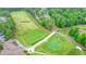 Aerial view of golf course driving range with a putting green and lush landscaping at 210 Malvern Pl, Roswell, GA 30076